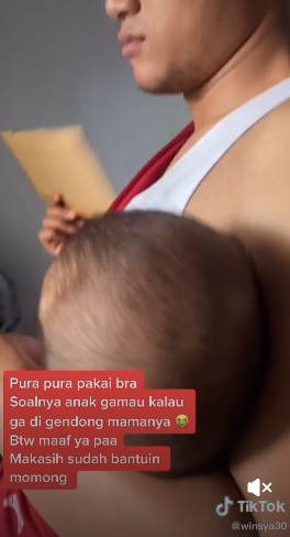 为安抚哭闹孩子 父穿胸罩模仿妻