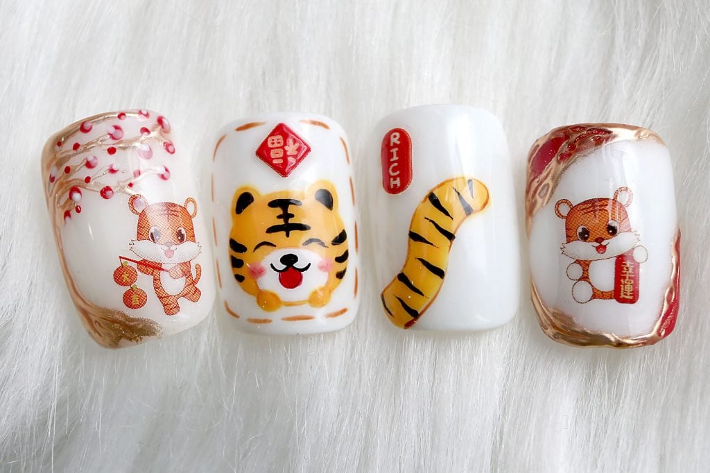 霹:20日见报/封底主文/【乐活频道】/新年美甲.应节Q版小老虎跃指尖萌萌哒