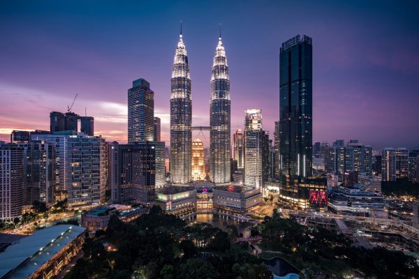 Kuala Lumpur, Malaysia - April 30, 2018: View of Kuala Lumpur City Centre aka KLCC complex including national landmark Petronas Twin Towers at twilight in Kuala Lumpur, Malaysia.