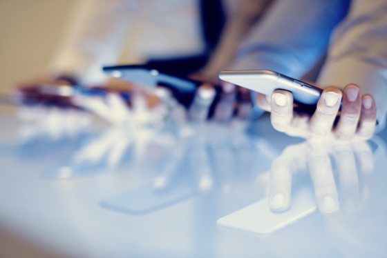 Hand holding using smartphone on hand