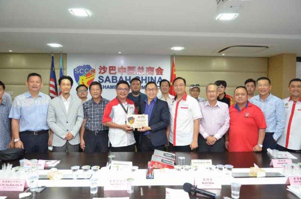 蔡绵贵（前右六）代表刘顺泰赠送纪念品予罗兰纳度（前左五）。