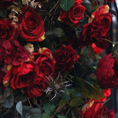 Pedestrians pass a display of red roses in London on the eve of Valentine's Day. AFP