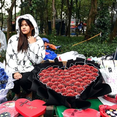A vendor selling flowers and chocolate bouquets at her street stall in Hanoi, Vietnam, on Valentine's Day. AFP