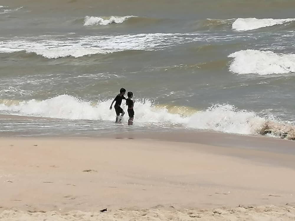 东:直落尖不辣海滩风大浪大并竖起红旗,惟稚儿不懂危险仍在海滩戏水。