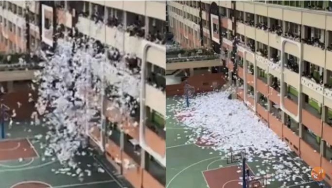 考完了！　　毕业生集体丢书下楼释压力　　校长：记得清就好