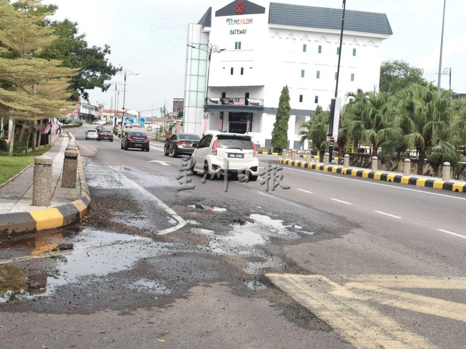 东:地下水管破裂造成路段出现多个大小坑洞及积水,驾驶者受促放慢速度,避免轿车受损。
