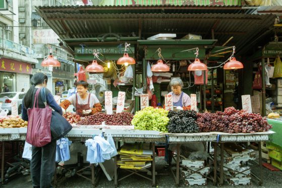 Woman Buying Vegetables In The Street Market, Hong Kong, February 17, 2014.