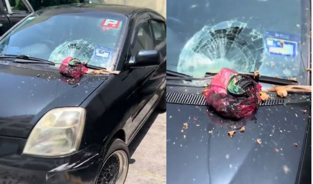 大厦居民随手扔下垃圾 砸破汽车挡风玻璃