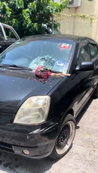 大厦居民随手扔下垃圾 砸破汽车挡风玻璃