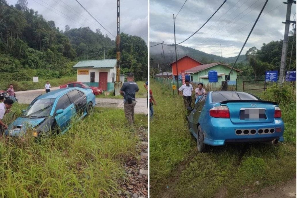 轿车卡轨道遭火车猛撞 男教师死里逃生!