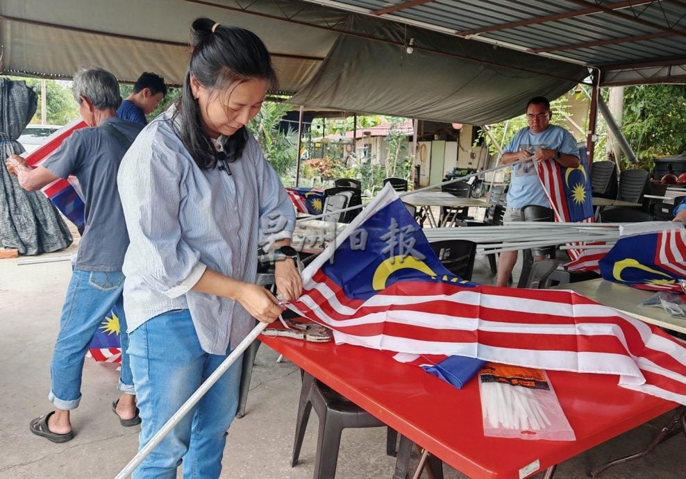 (大北马)马青亚罗士打区团走入太子路过港,为居民悬挂国旗。