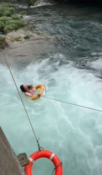 视频|大妈景区拍照跌入水中 安全人员抛救生圈救回