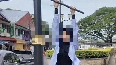 3男女攀路牌路灯柱画面疯传 古晋北市市政局：有碍市容 报警调查