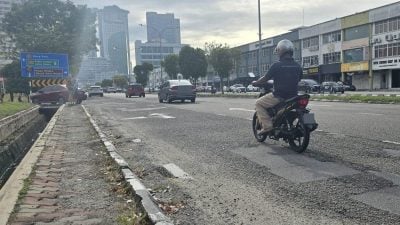 布满沙石危及骑士  甲拉也9路 坑洞处处 