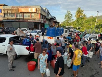 民众受促带桶盛装 . 水车到尼亚石山镇派水